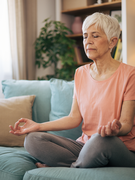 image of a woman meditating in her home