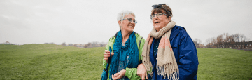 Two older women walking in a field