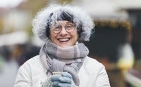 Senior woman enjoying a warm drink on a cold day