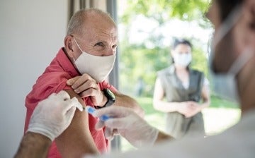 Senior man receiving the vaccine from doctor