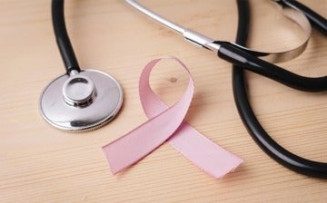 Close up of stethoscope and Breast Cancer Awareness ribbon