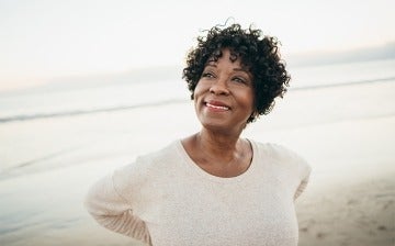 Mature woman looking peaceful at the beach
