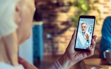 Mature woman speaking to a doctor on a smartphone