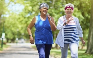 Two elderly women enjoying a brisk walk