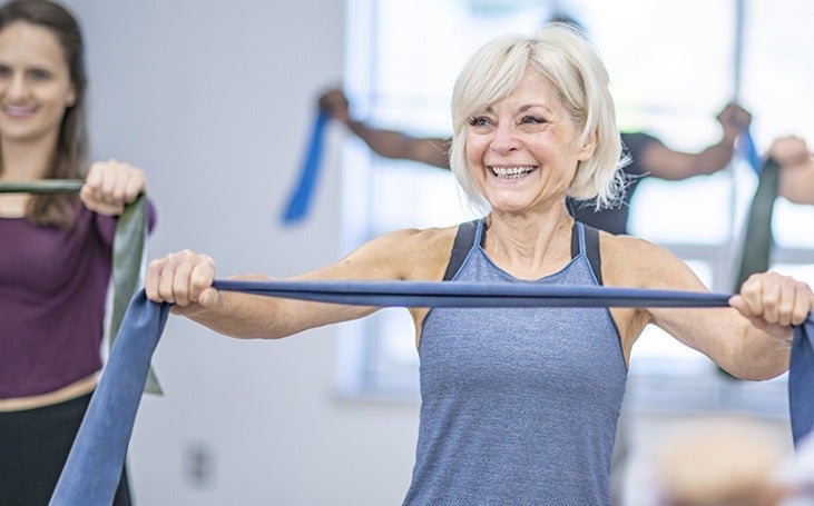 Woman in exercise class with resistance band