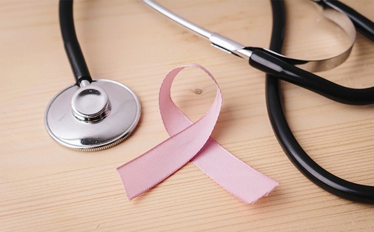 Close up of stethoscope and Breast Cancer Awareness ribbon 