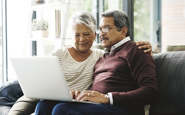 Mature couple reviewing information on a computer screen together