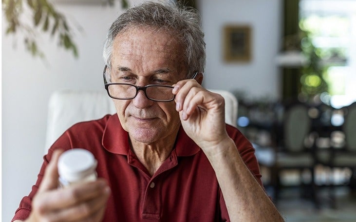 Man reviews label of prescription bottle